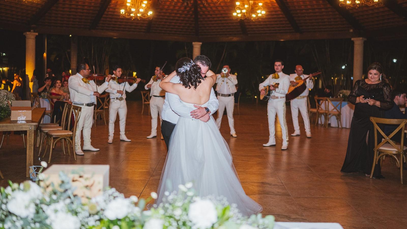 A couple dancing at their wedding reception while a live band plays