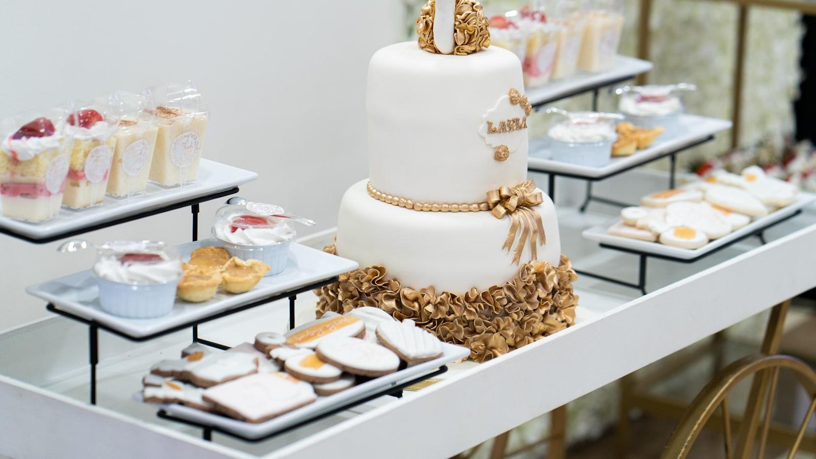 A softly decorated baby shower dessert table with cake and pastries