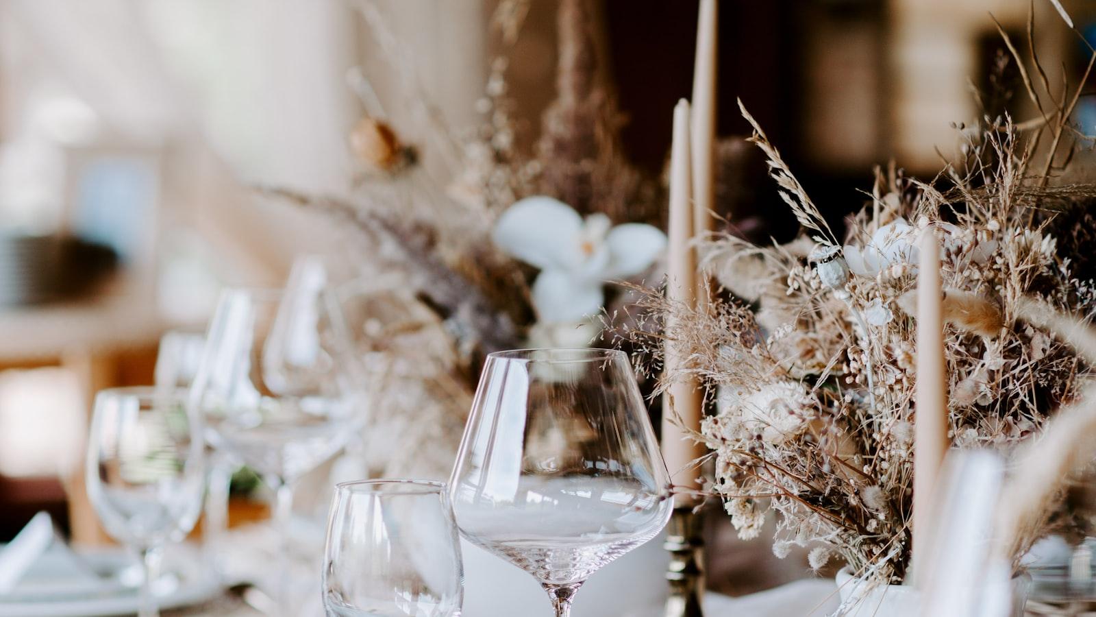 A naturally styled dinner table with dried florals, linen and candles