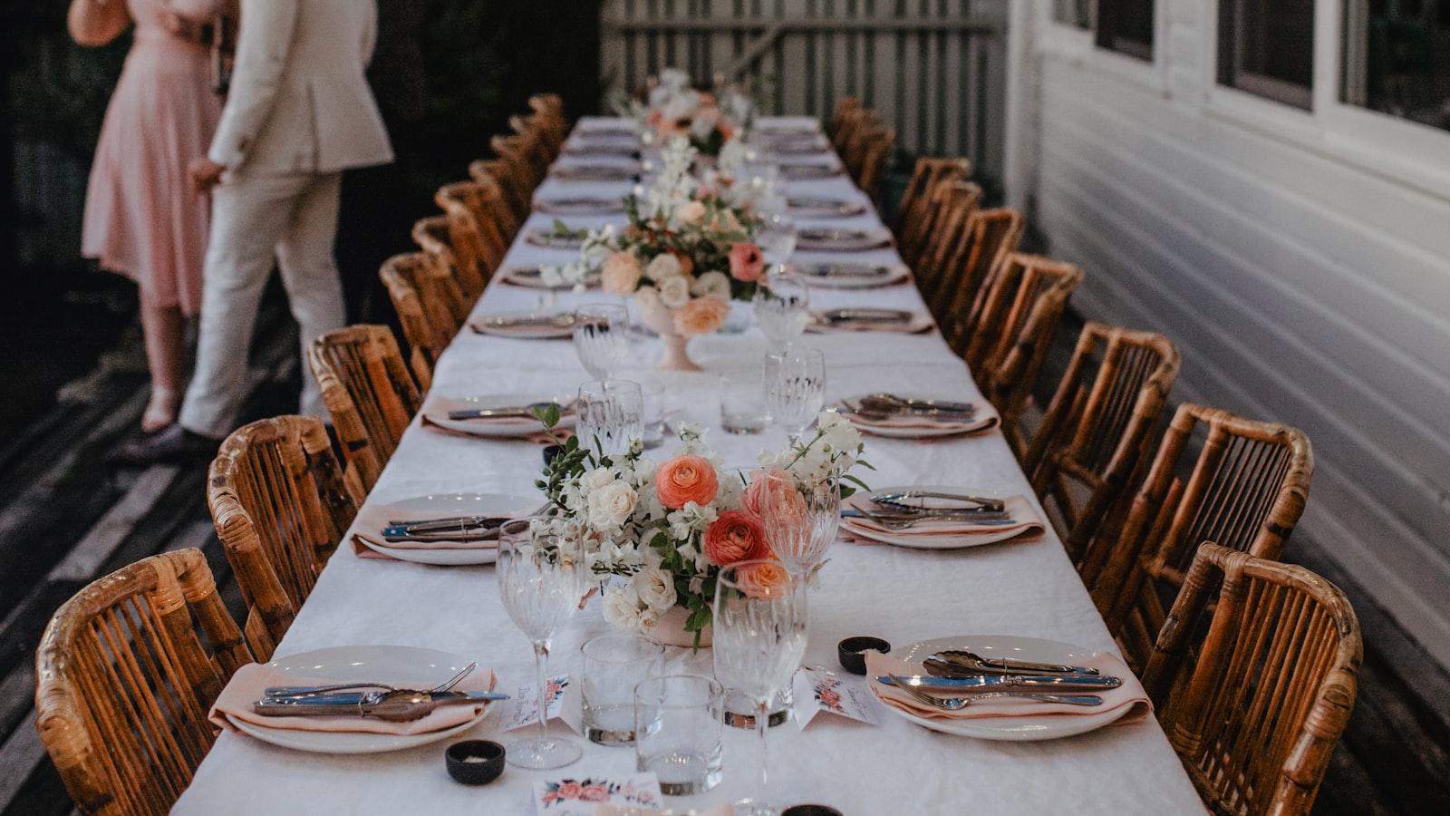 A couple standing at the head of one long table at their small wedding
