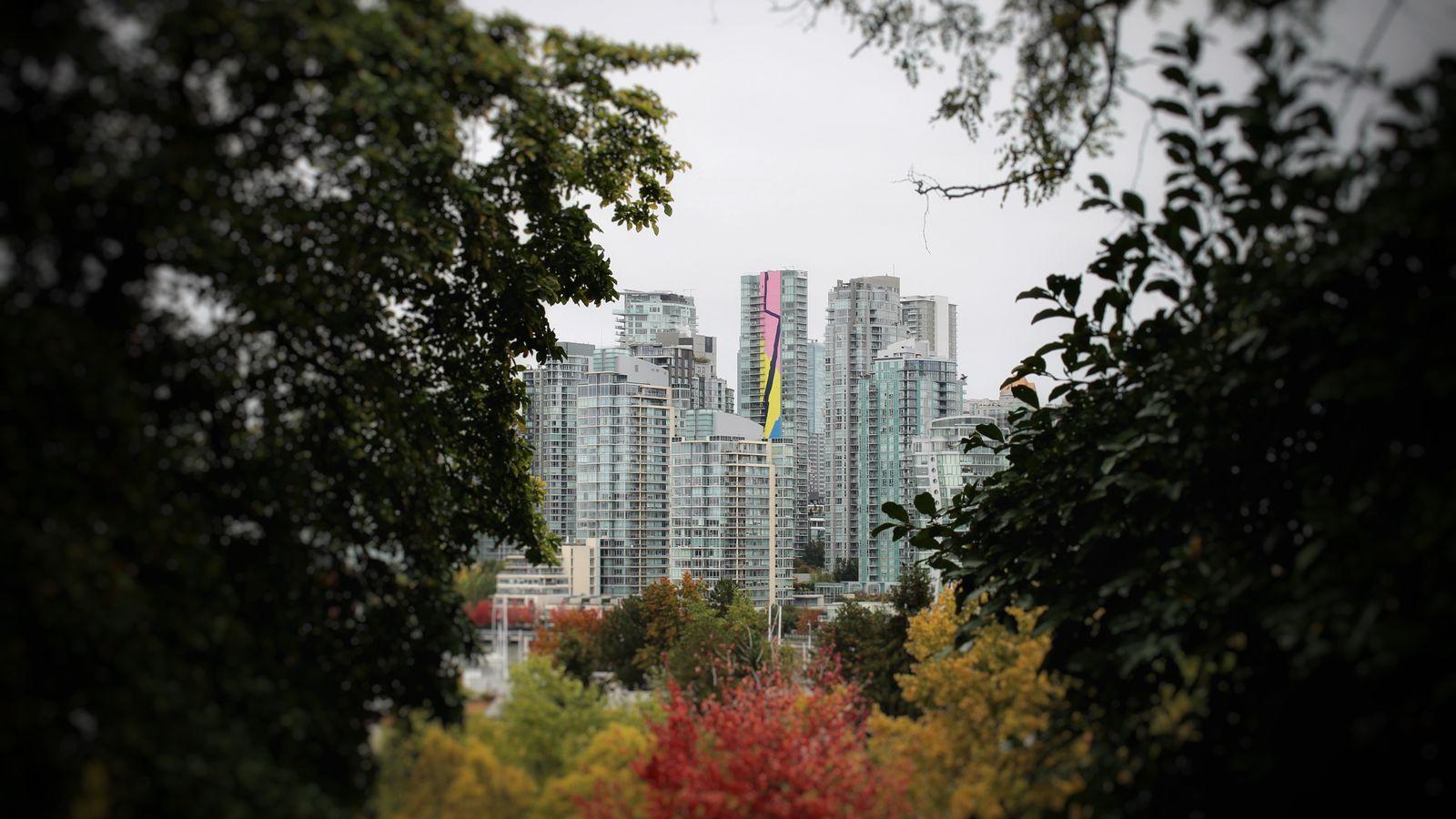 Orange and yellow autumn trees in front of the Vancouver skyline