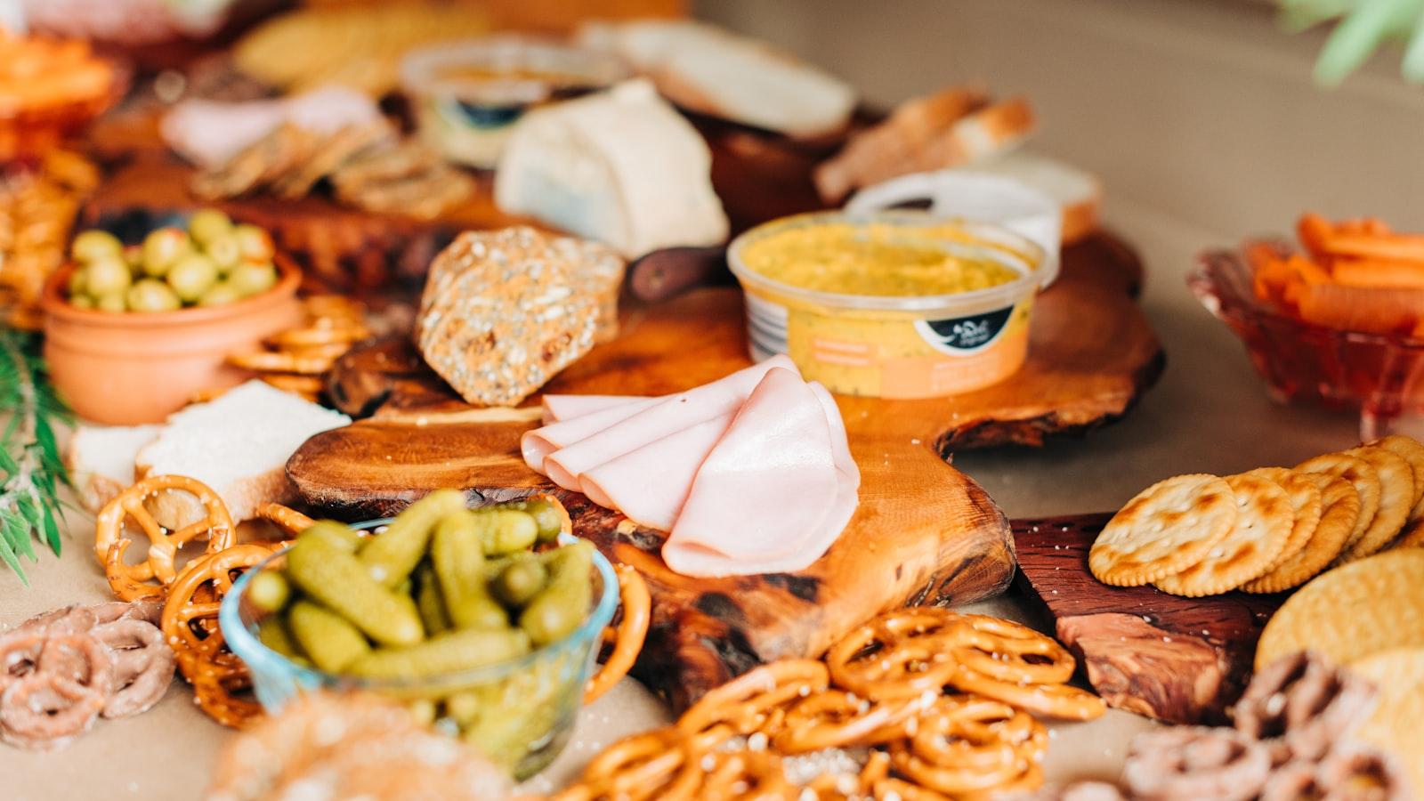 A long grazing table piled with cheeses, fruit, cured meats and bread